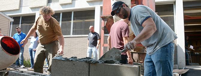 students working on a masonry project